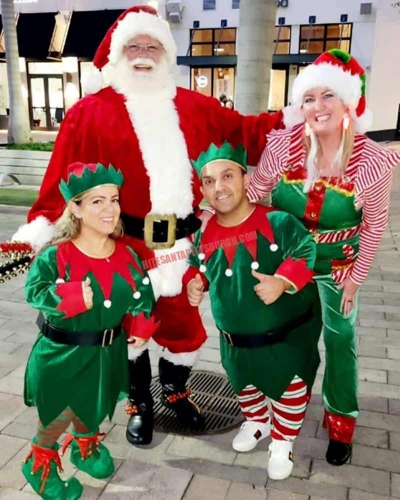 Santa and three elves in costume, ready for a school Santa visit or church Christmas party