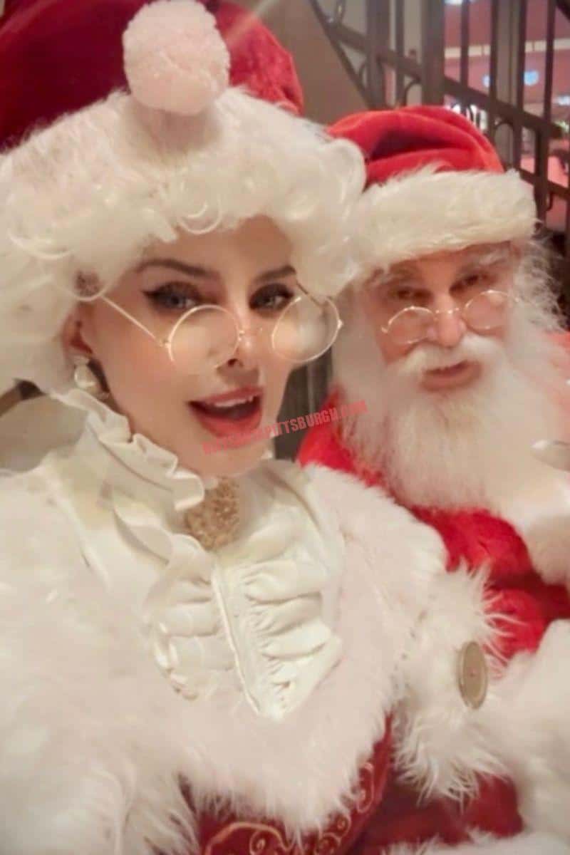 Santa and Mrs. Claus smiling together in their red and white holiday costumes